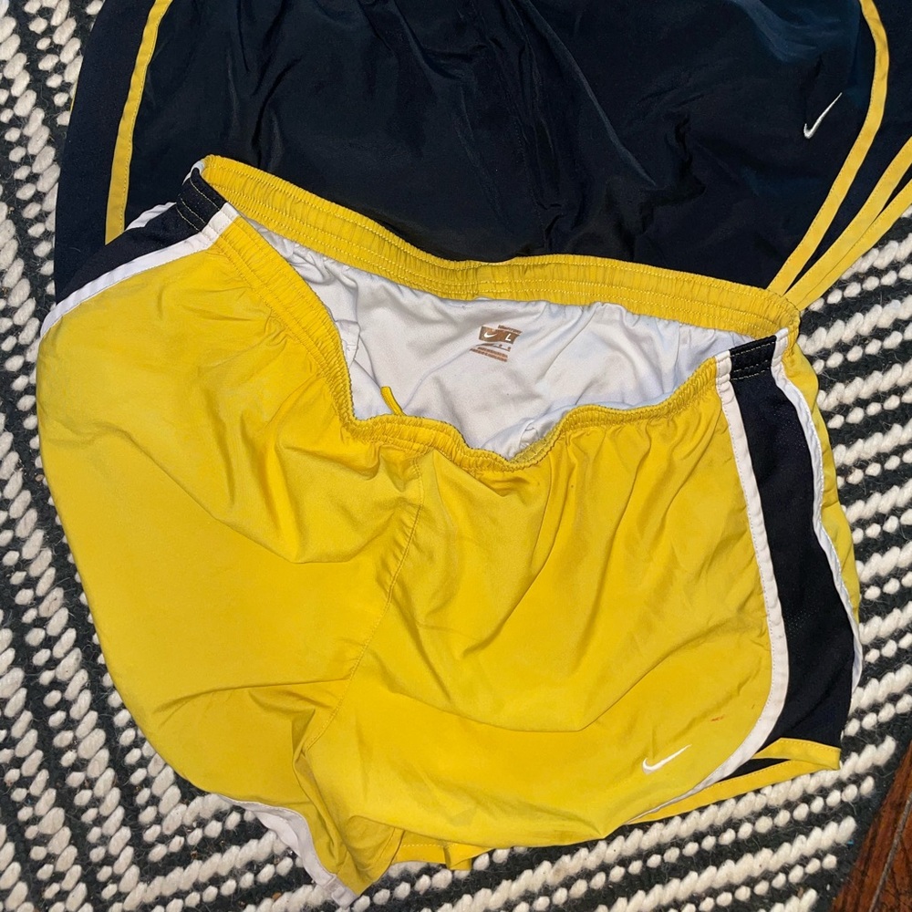 Two. Black and yellow Nike shorts. With liner.